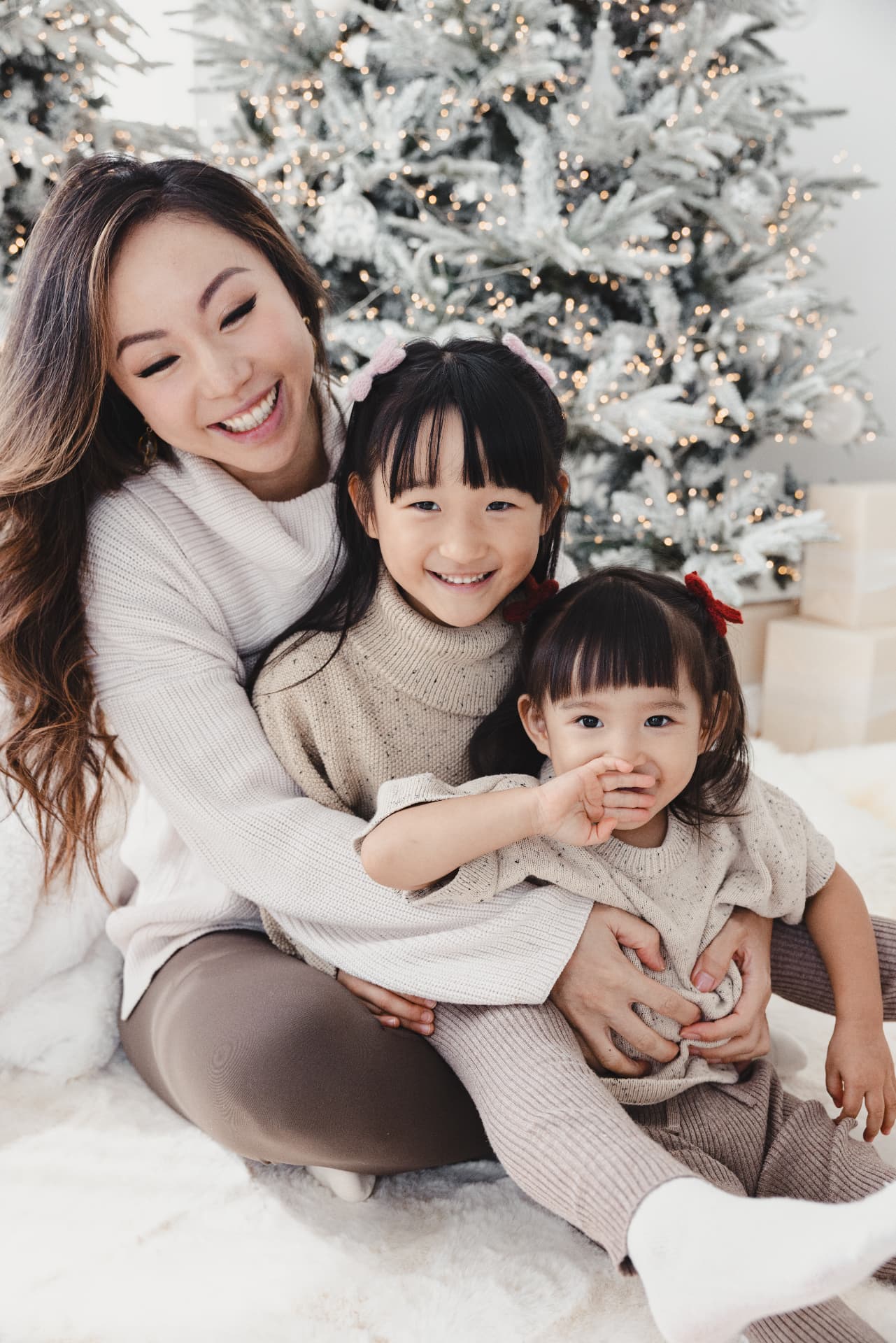 Jojo smiling with her two daughters